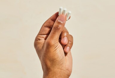 hand holding white supplements